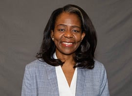 Carline Guerrier, RUSH Specialty Hospital Chief Nursing Officer, smiles at the camera wearing a gray blazer.
