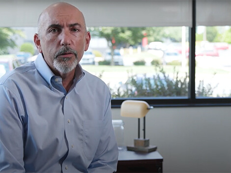 Doctor Hammerman, sitting and speaking to the camera about Select Medical's 5 whys.